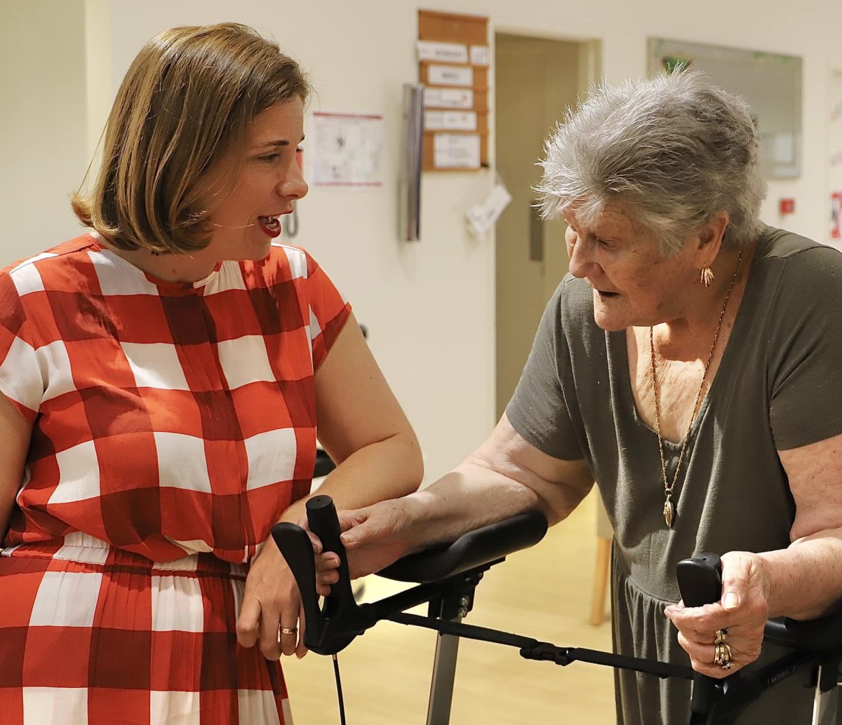 Aged Care Minister Anika Wells chatting with an elderly person at a facility in Rosewood, Queensland