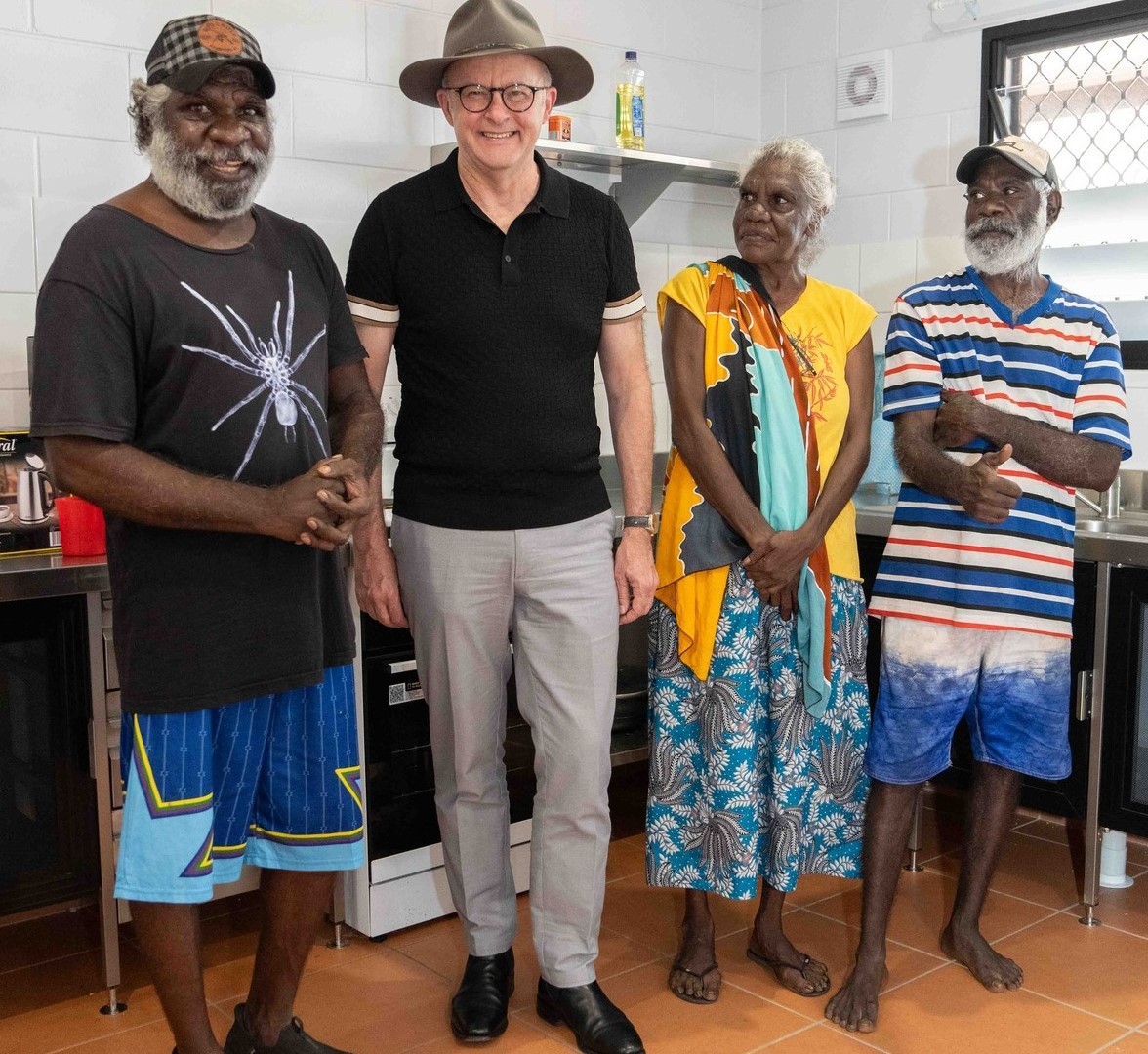 The PM standing in a kitchen with a few Indigenous locals in Katherine, NT.