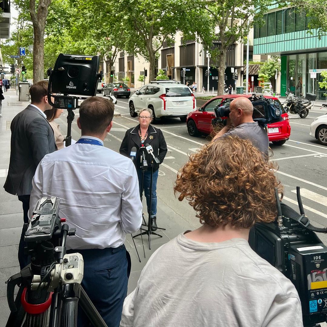woman speaking to media on the streets of Melbourne