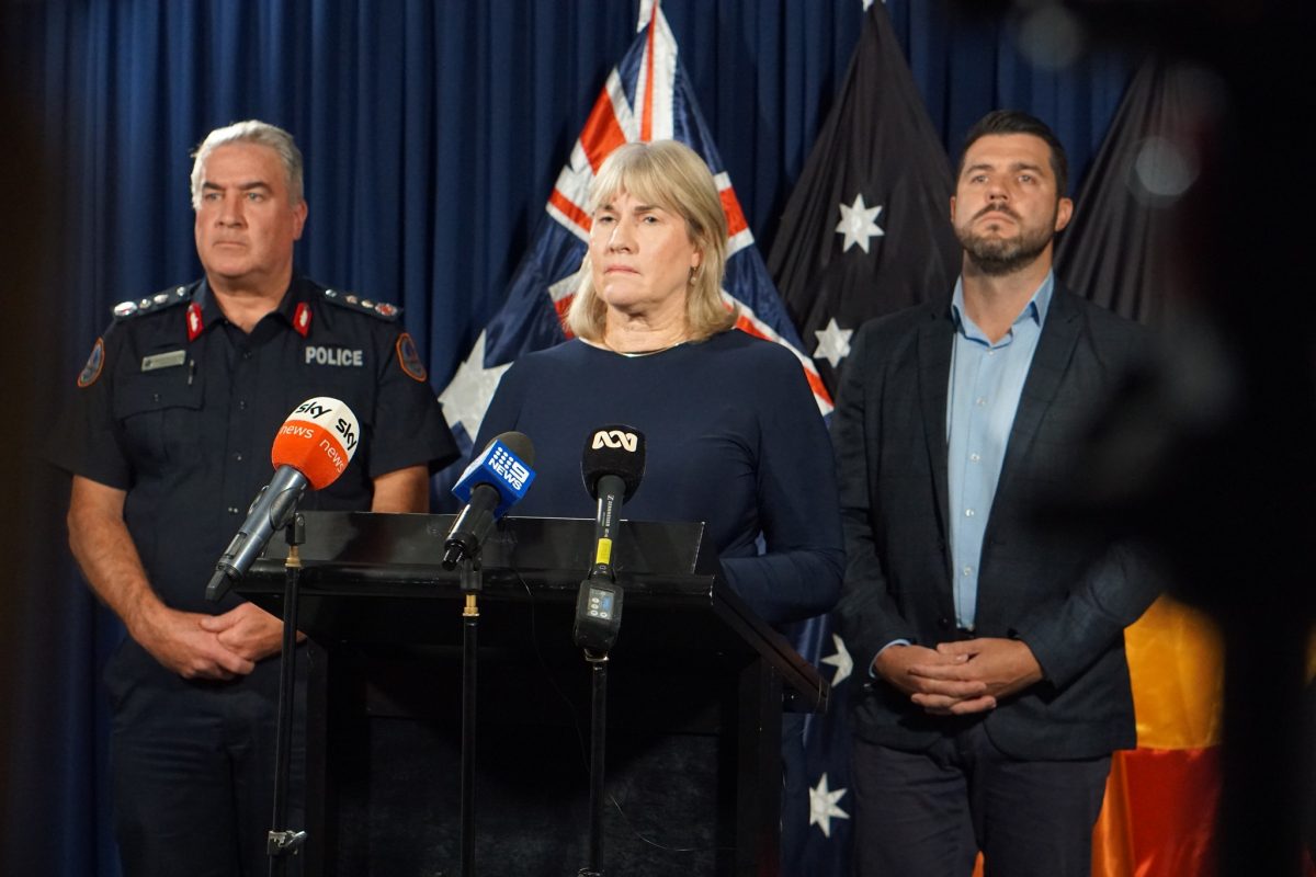 a police officer and two politicians giving a press conference