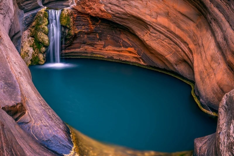 national park waterfall surrounded by red rock