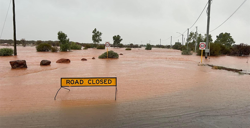 Flooded road with a sign reading ''ROAD CLOSED''