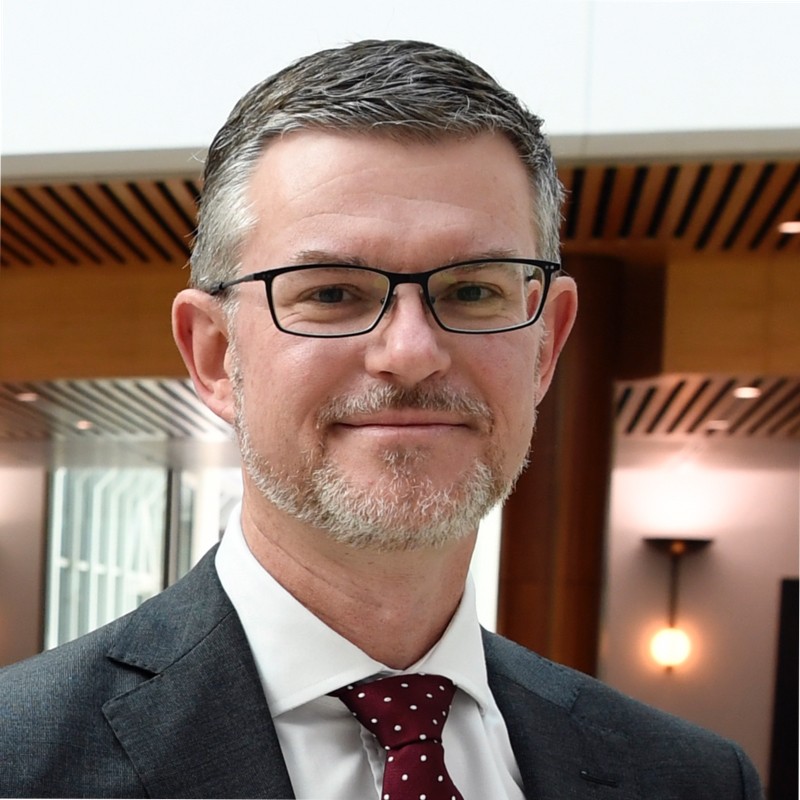 smiling man in a suit in an office