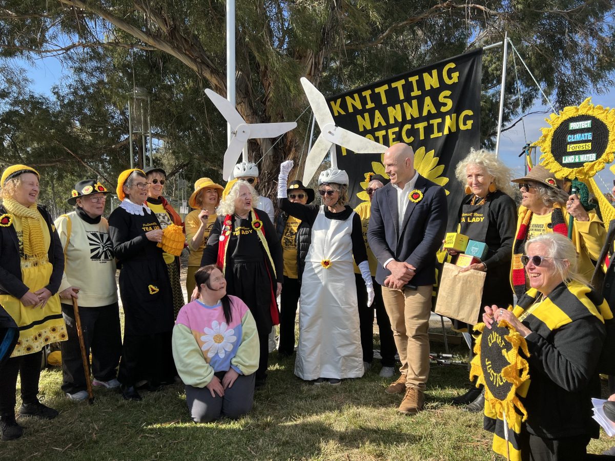 Knitting Nanas protesters standing with ACT Senator David Pocock on the lawns of Parliament House.