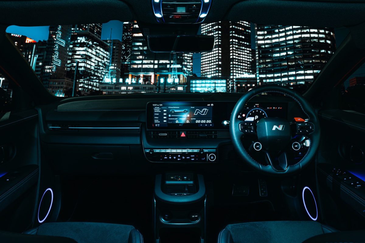 car interior and city buildings lit up