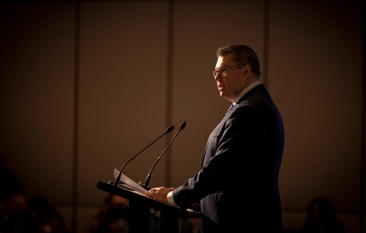 man speaking at lectern