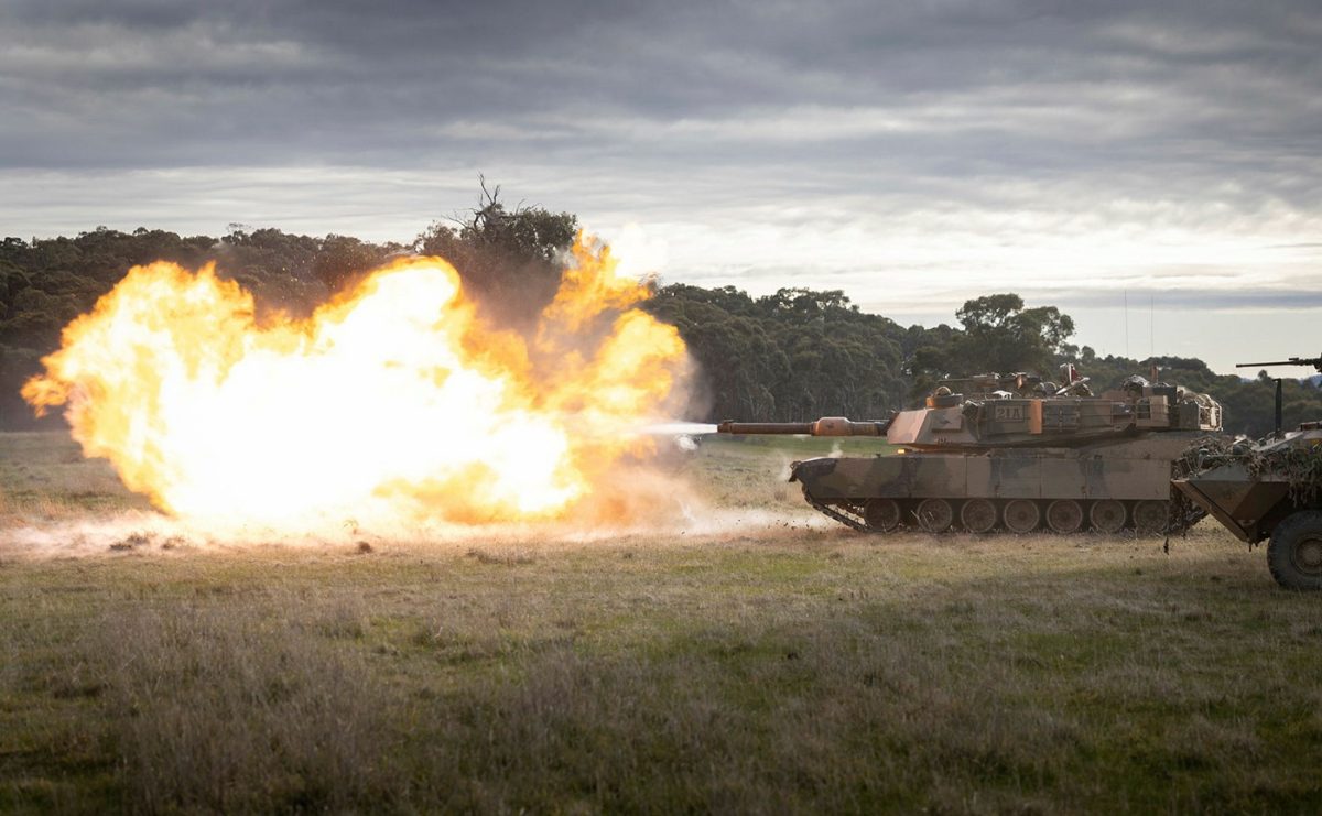 Army tank blasting a target