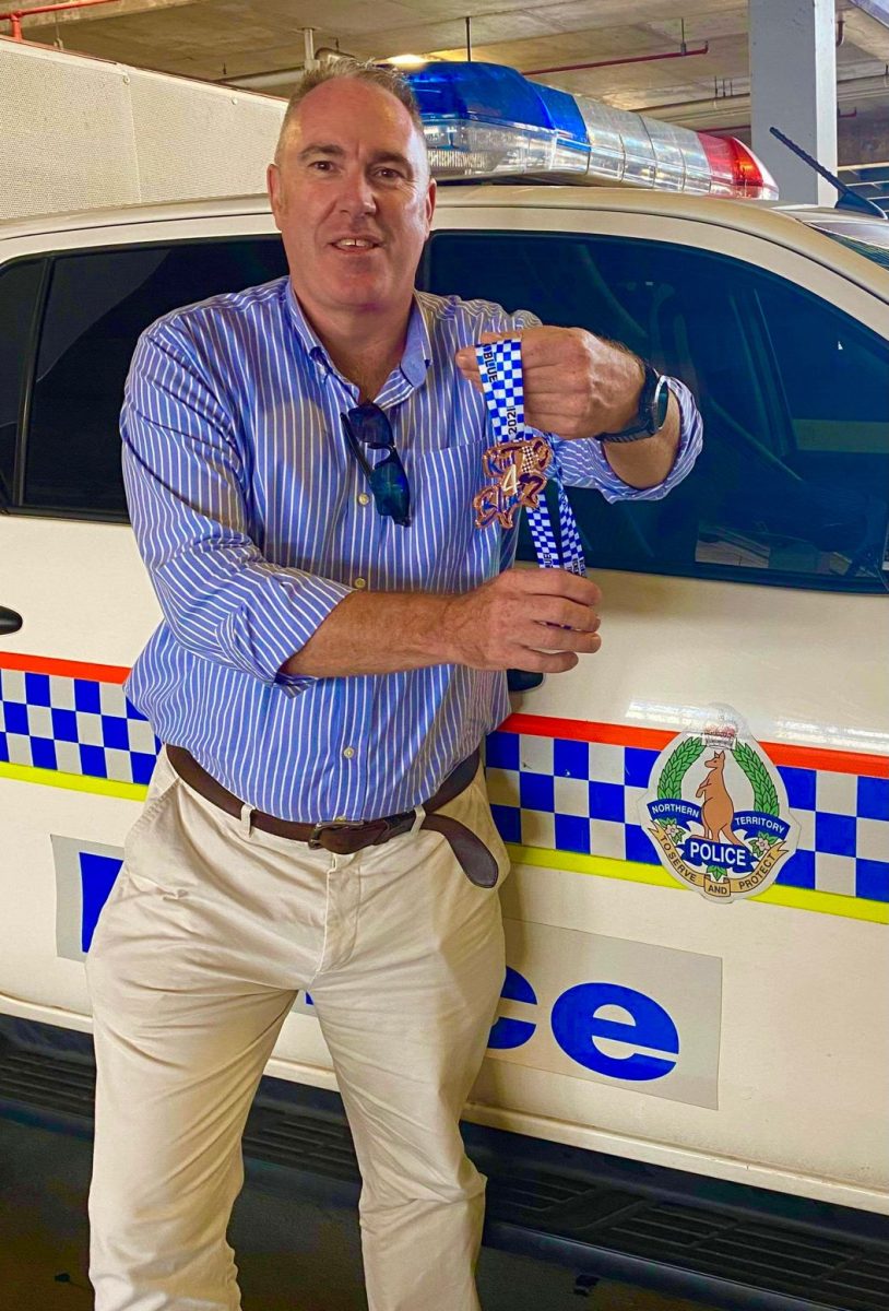 man holding a medal