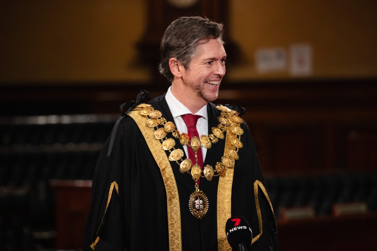 smiling man in mayoral robe
