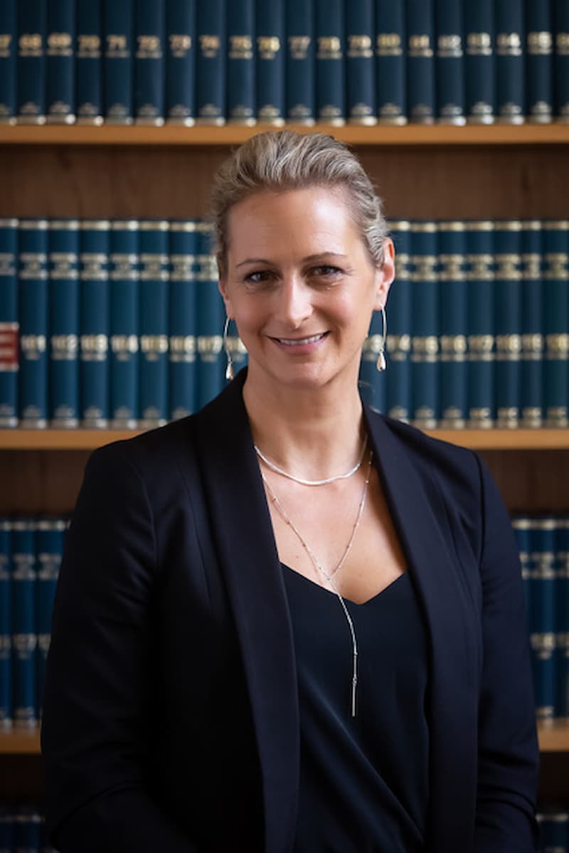 woman standing in front of an office bookcase