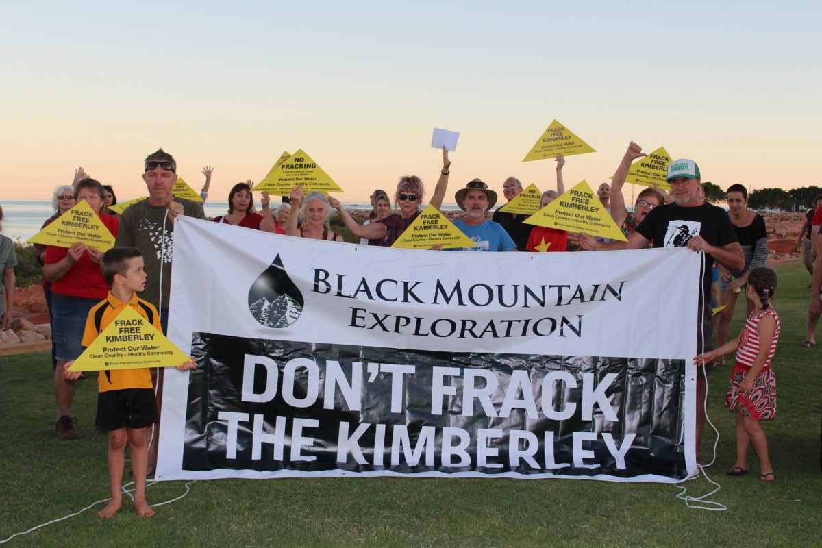 A group of people in Broome hold up a sign calling for Black Mountain to not frack the Kimberley.