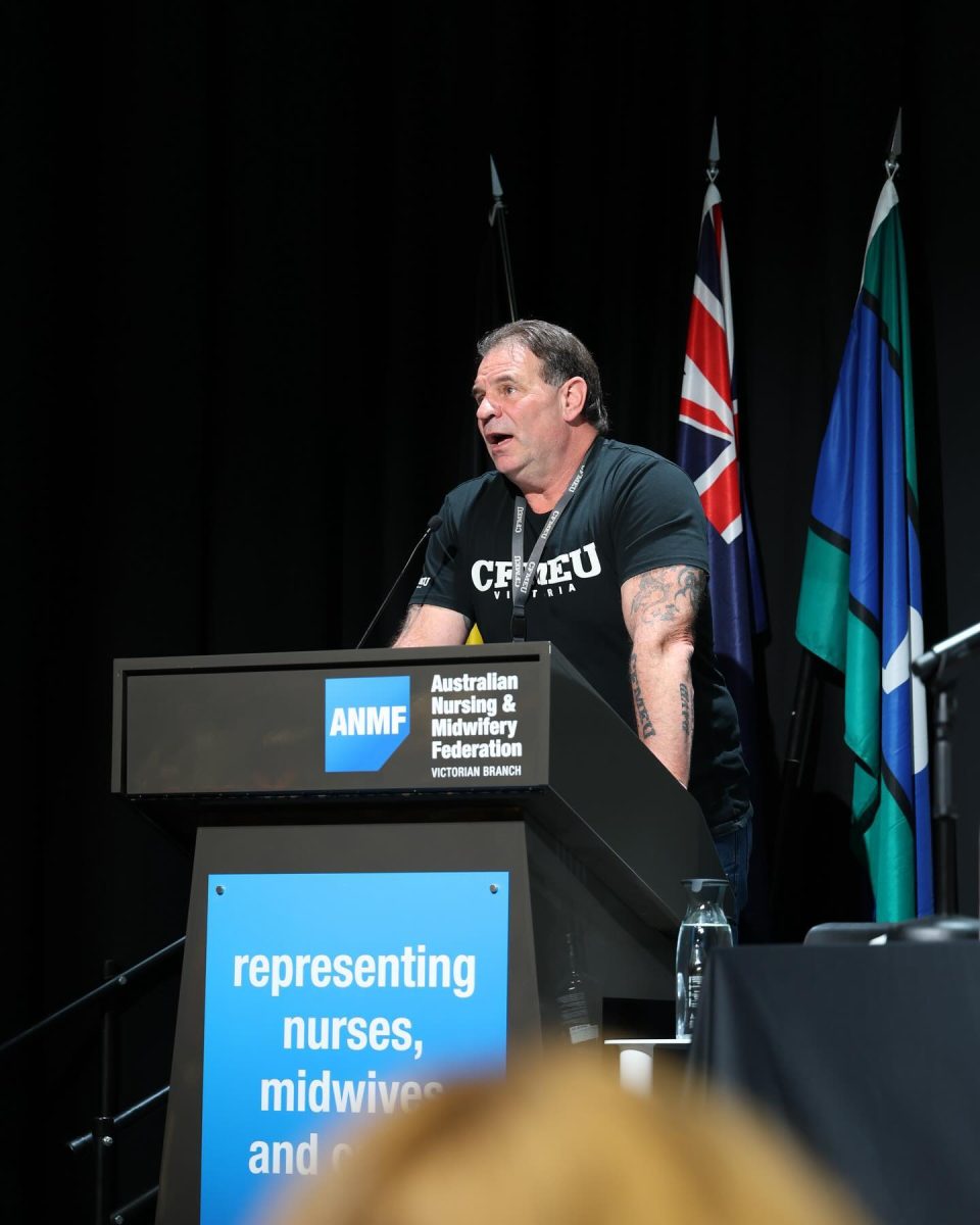 man speaking at lectern