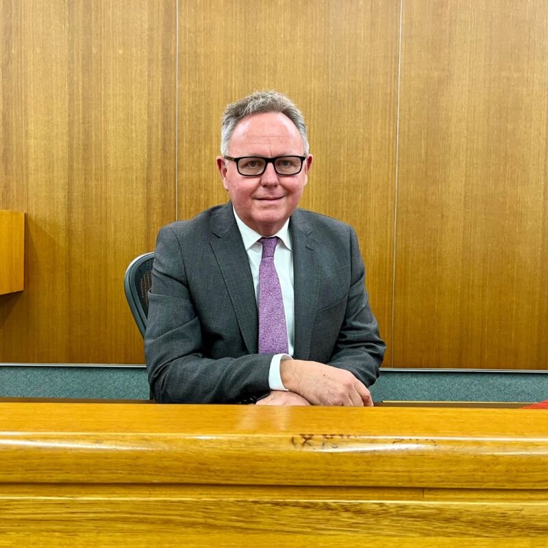 suited man sitting in a court