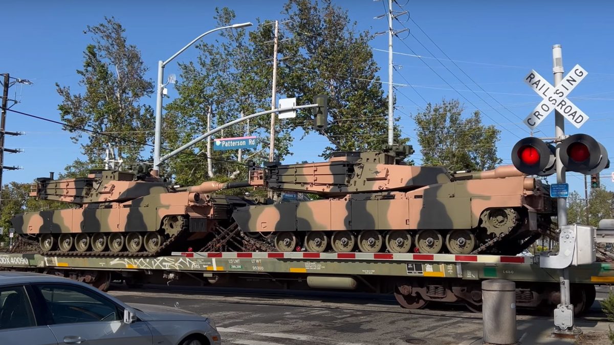 army tanks being transported by train