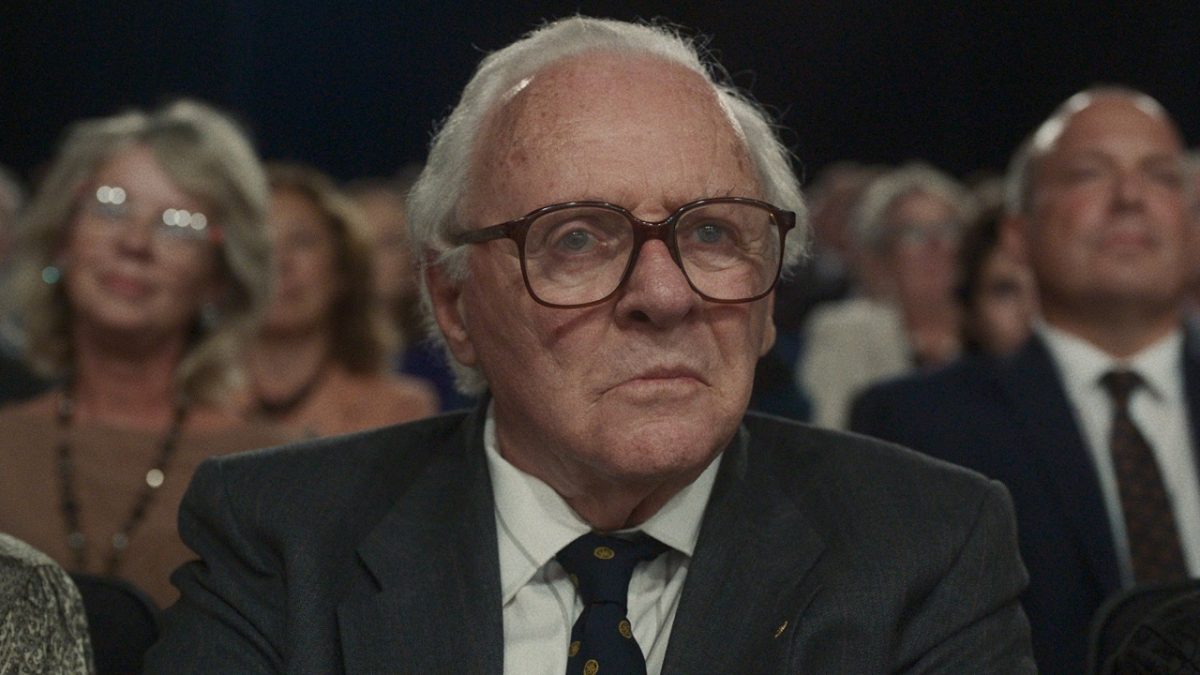 elderly man sitting in the audience