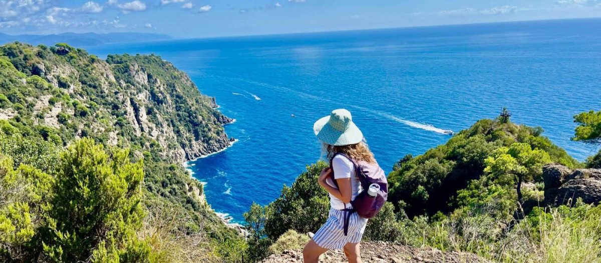 woman walking along a coastline