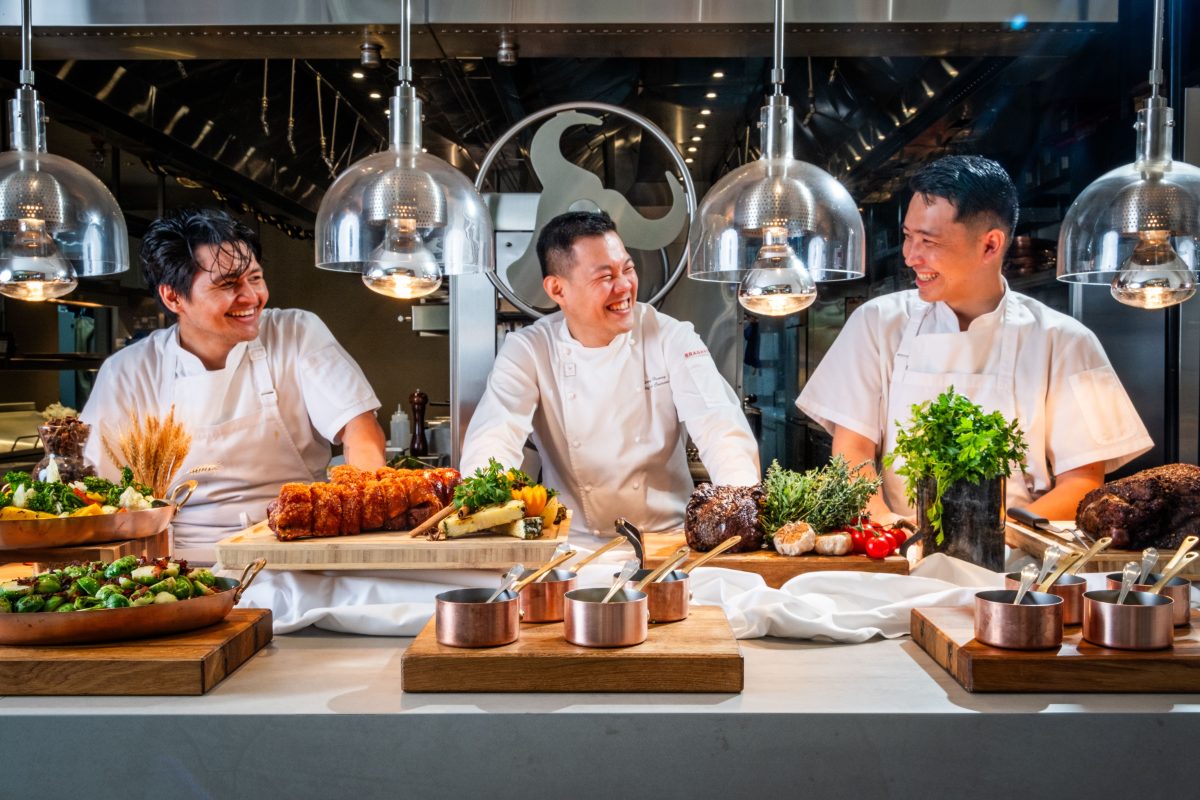 three chefs in a restaurant kitchen