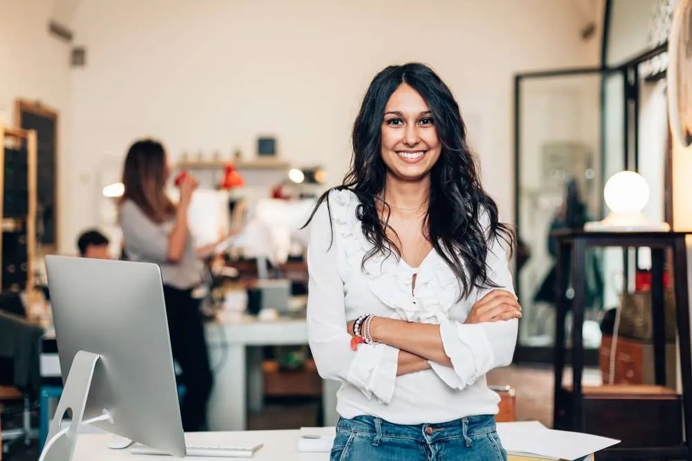 woman standing next to her office desk