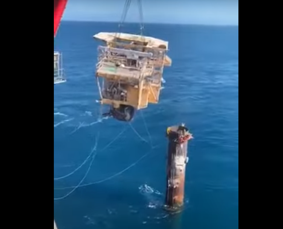 Screenshot of the incident, showing the severed head of a platform swinging from a crane, narrowly missing workers.