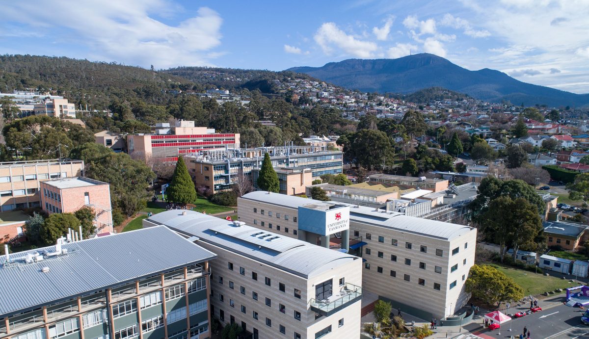 An aerial view of the UTAS Sandy Bay campus with kunanyi Mt Wellington in the background.