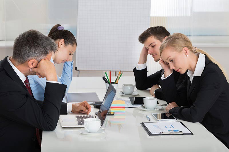 Bored-looking people at their desk