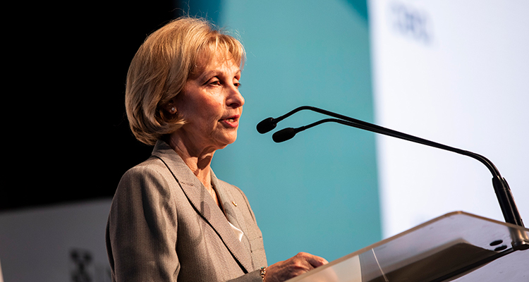 woman speaking from a podium