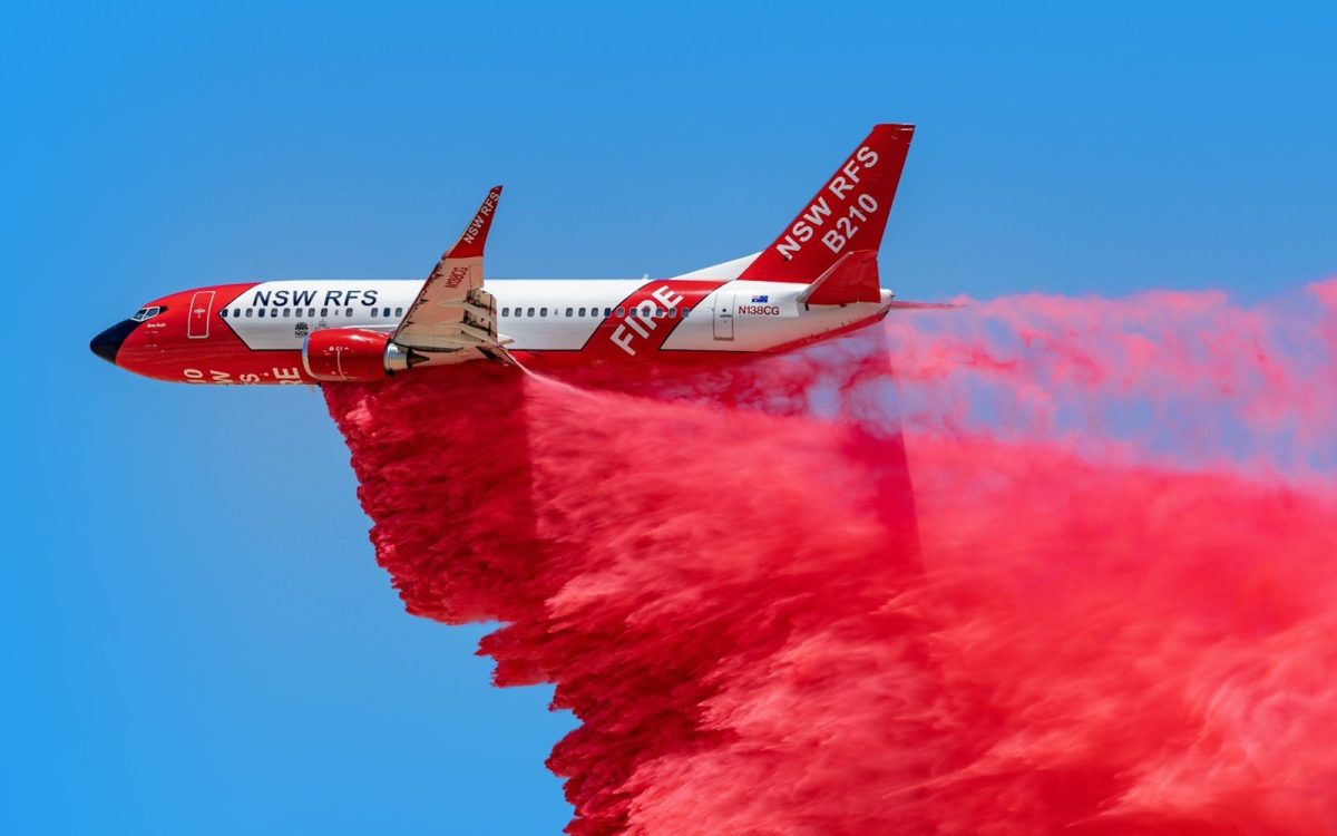 plane dropping retardant on bushfire