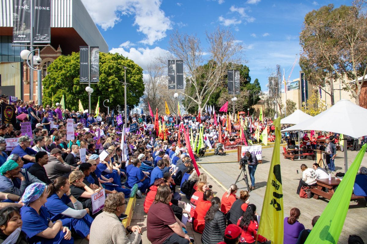 Hundreds of protesters in various colours gather outside the Perth Cultural Centre.