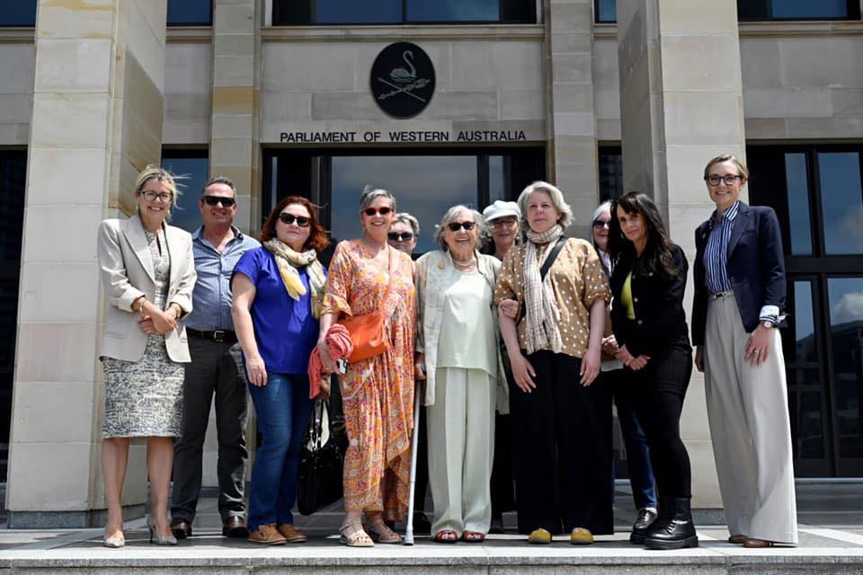 A group of individuals standing in front of WA Parliament.