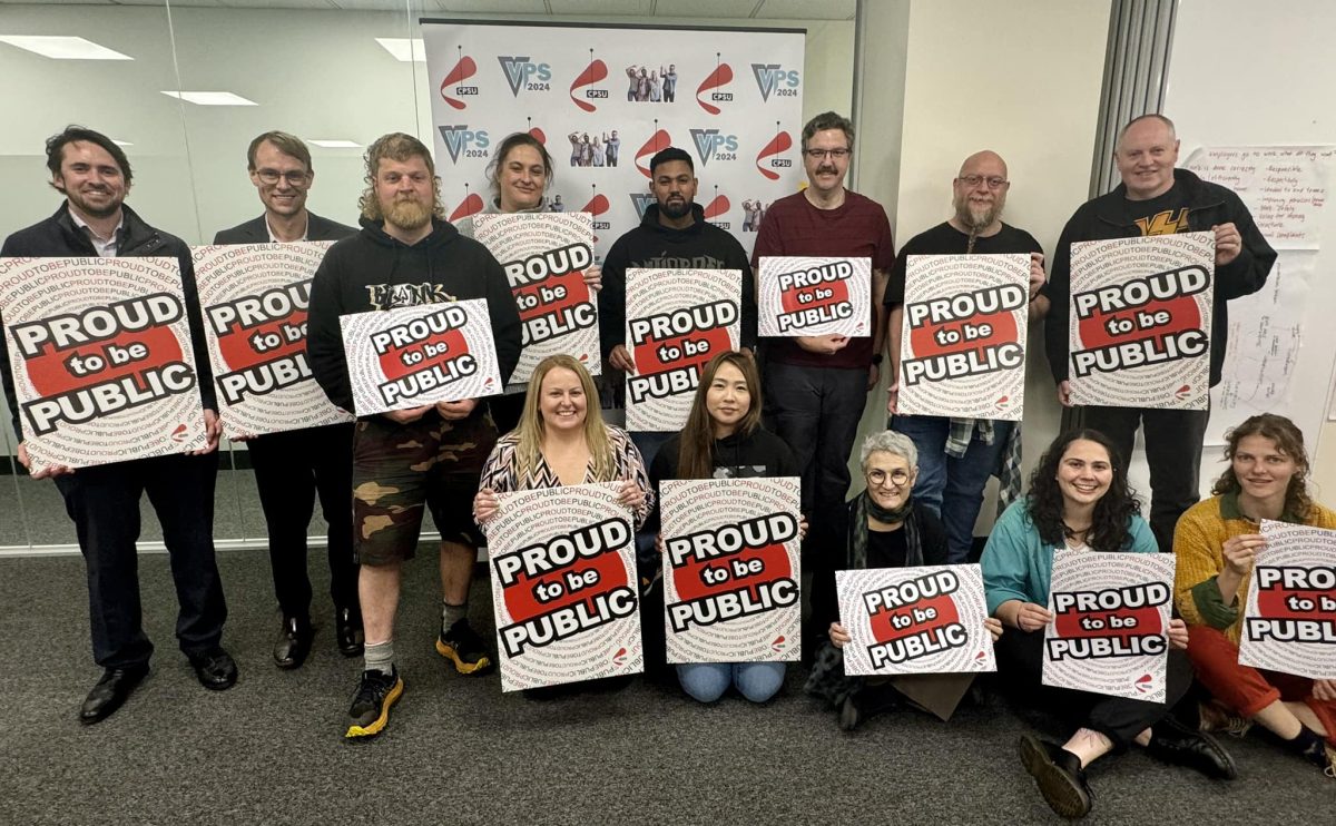 A group of people holding up signs reading: 'Proud to be Public'