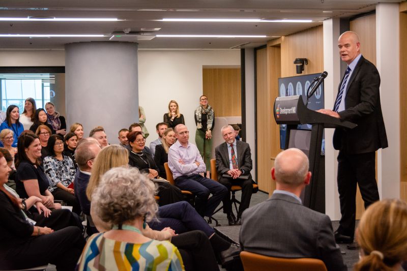 man at lectern addressing the audience