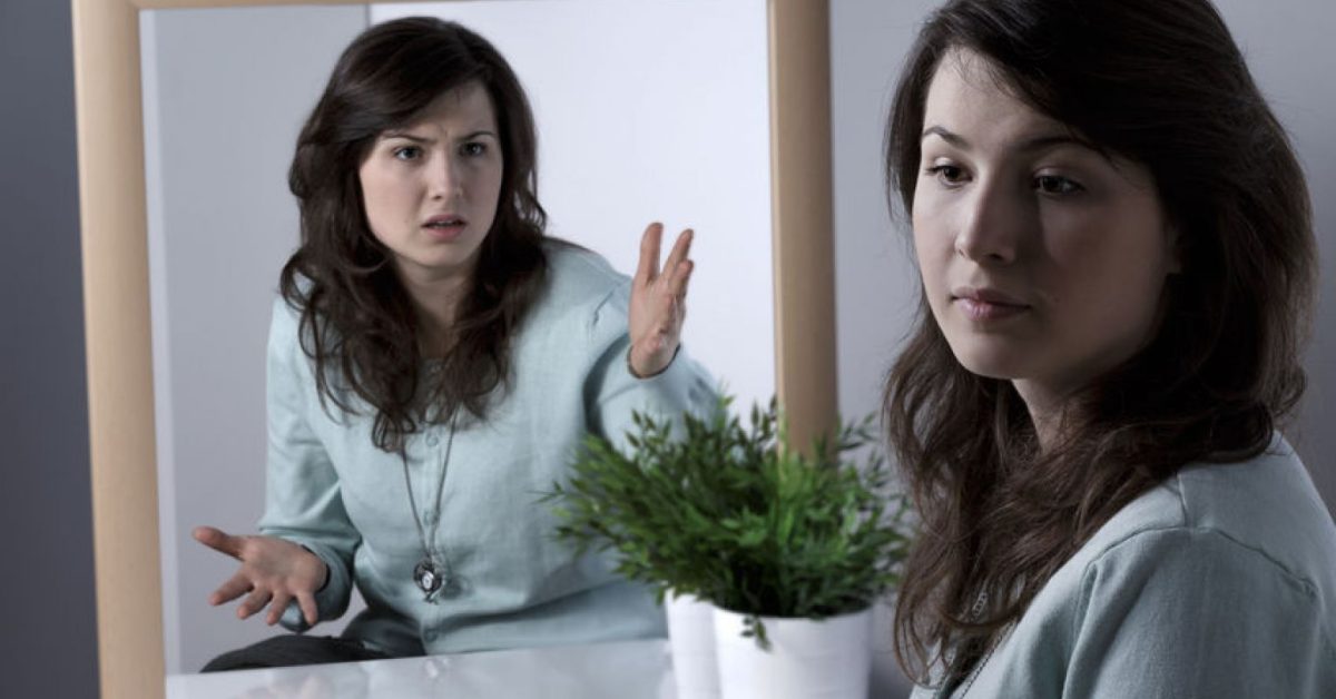 Woman's angry reflection in mirror