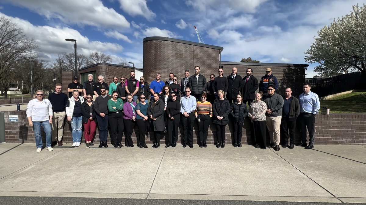 A group of AFP staff standing together outside the Belconnen Police station.