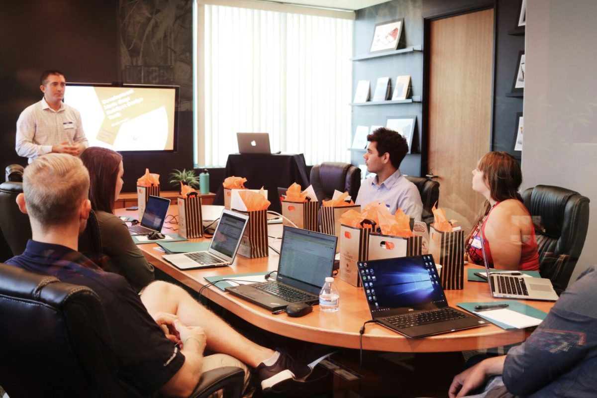 a man giving a presentation to a small group in an office