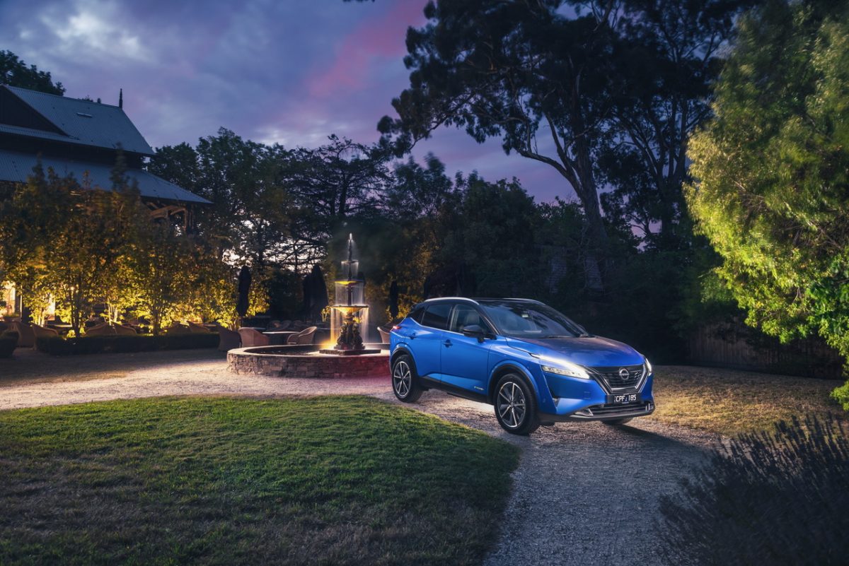 Nissan Qashqai Hybrid in front on a garden fountain