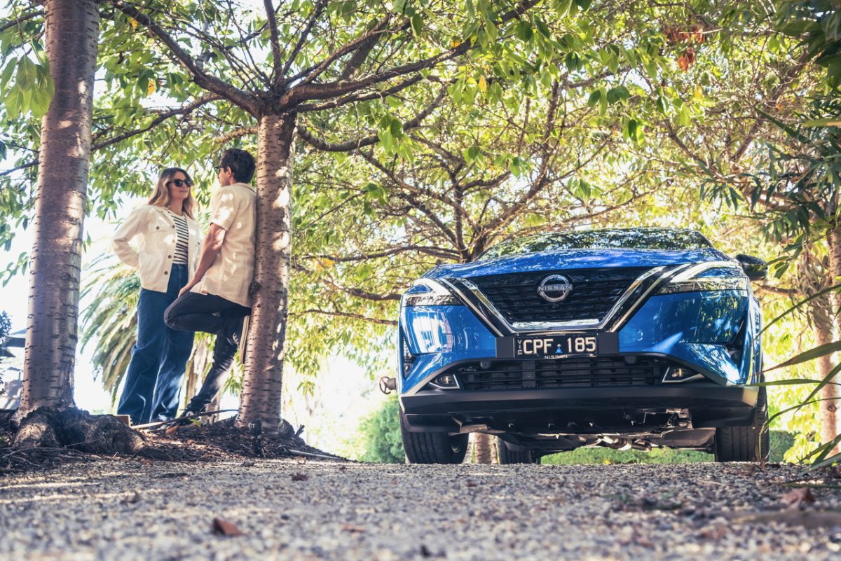 two people standing near a car