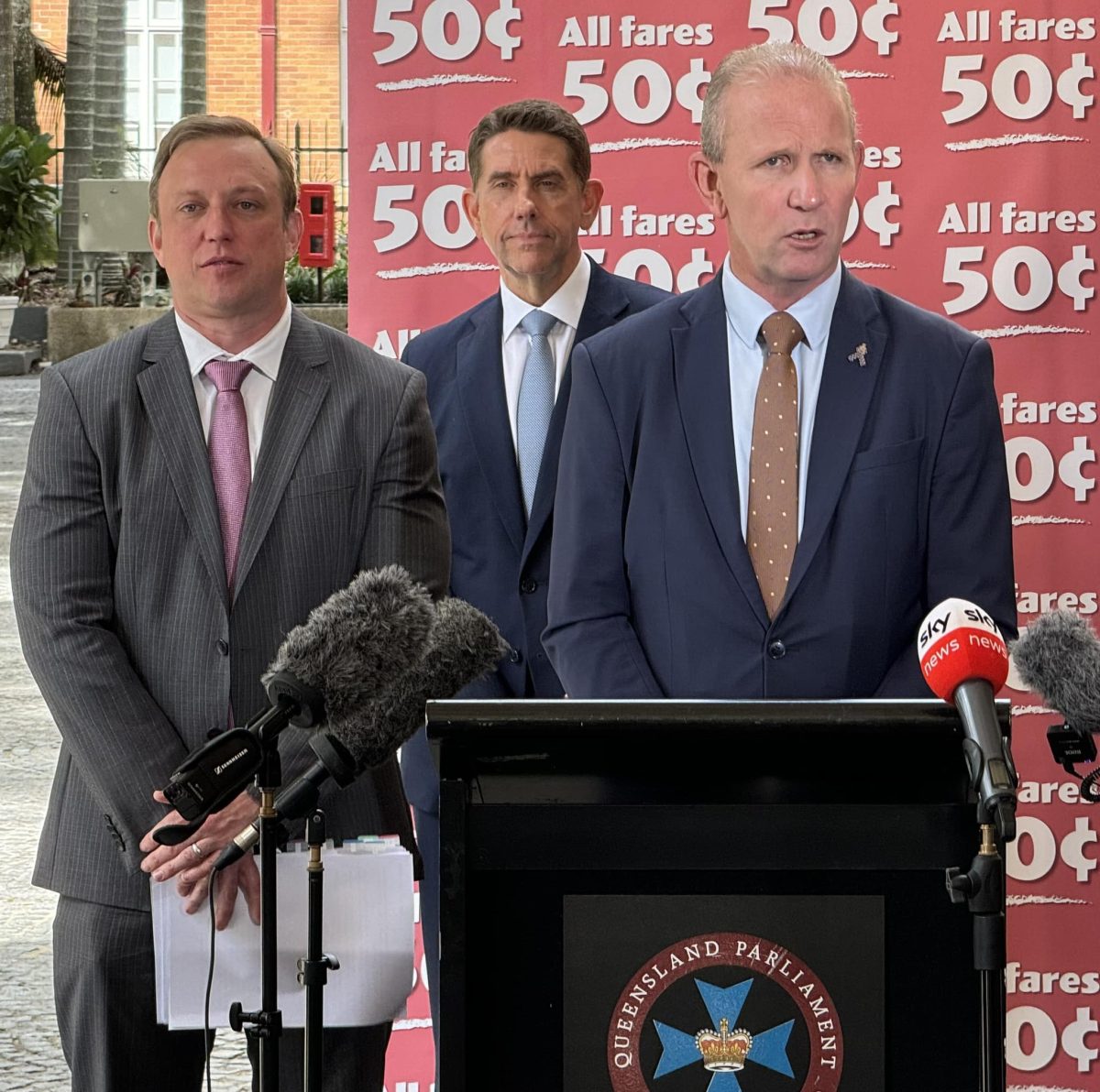 Three politicians at a press conference