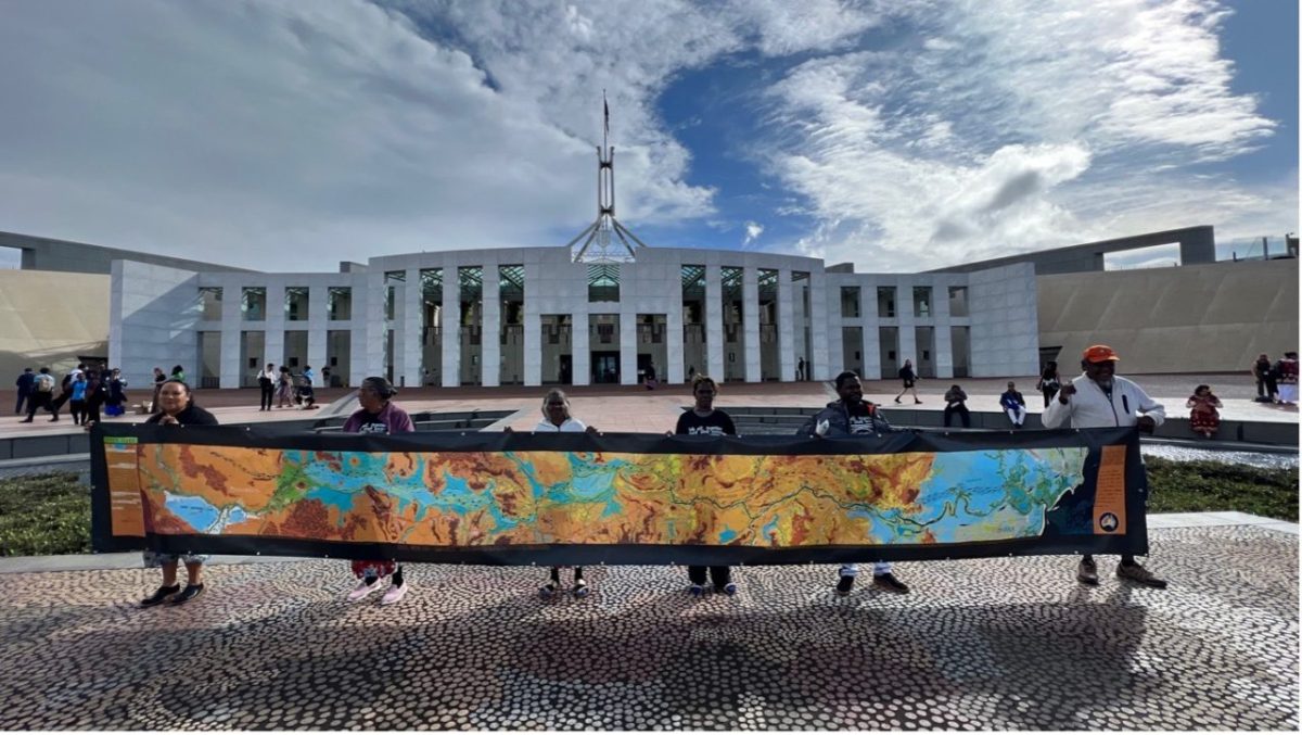 Roper River delegates with a small version of the Roper River Songlines Map outside Parliament House, Canberra in November 2023.