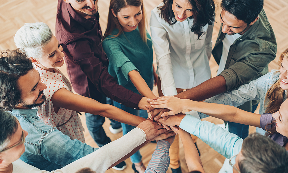 Group of diverse people holding out their hands