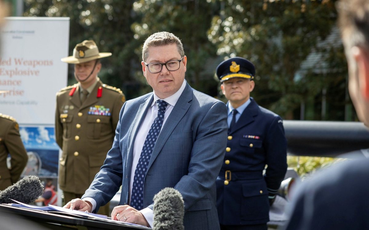 politician and defence force officers at press conference