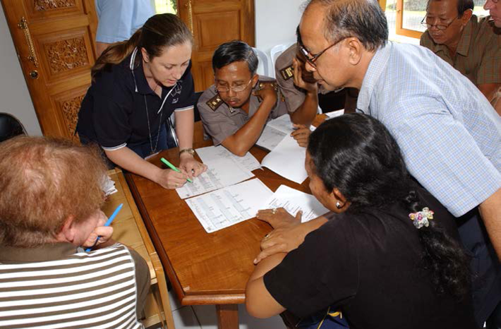 People looking at documents on a table