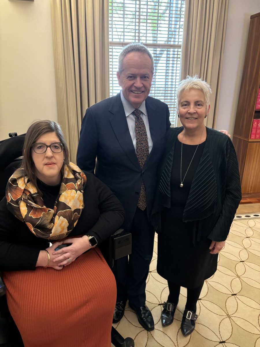 a man with two women in his office