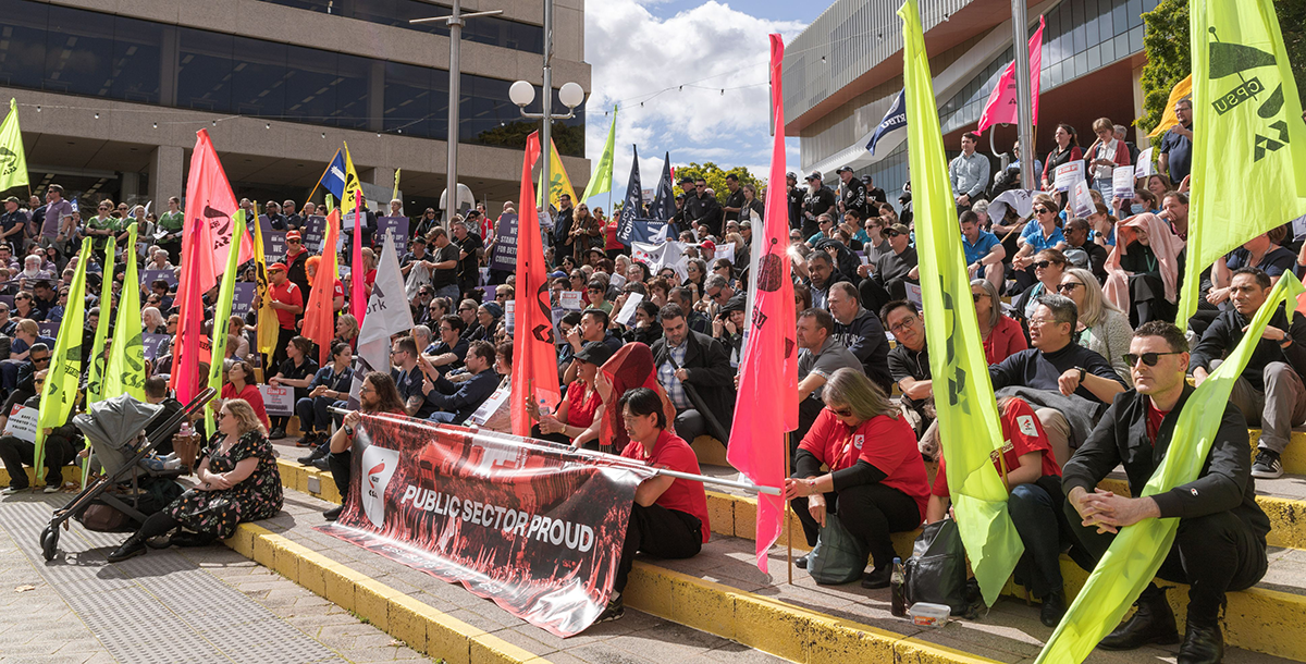 WA public sector workers holding flags while at a rally.