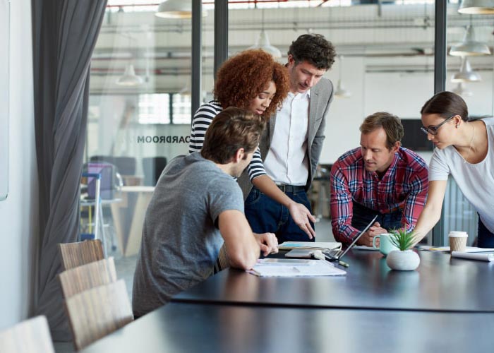 group of people talking around an office table