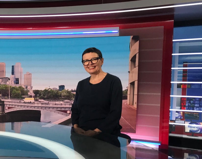 smiling woman in a TV studio