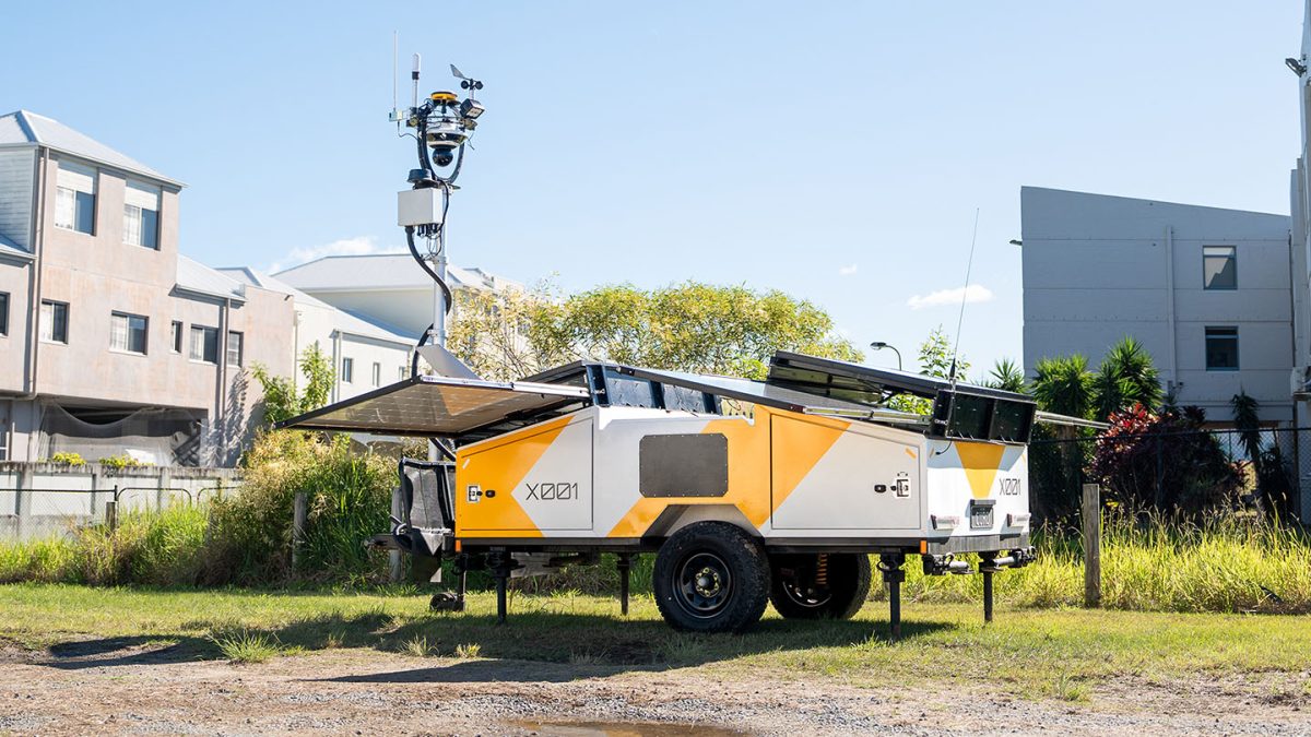 A hubx with solar panels and a sensor stack sticking out of it. 