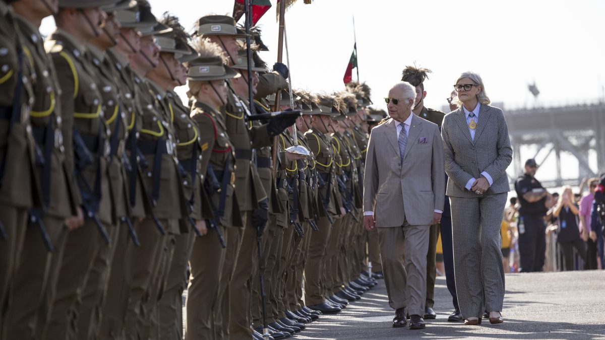 a man and a woman inspect troops