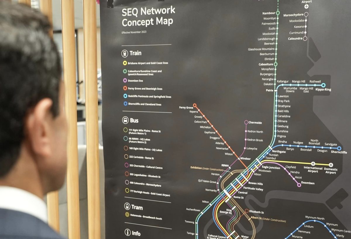 Premier David Crisafulli looking at a map of the South East Queensland rail network.