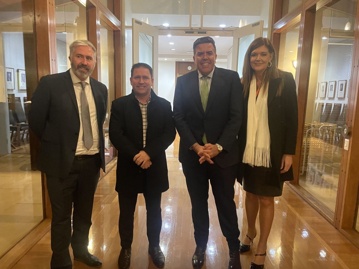 four people standing in a hallway at Parliament House, Canberra