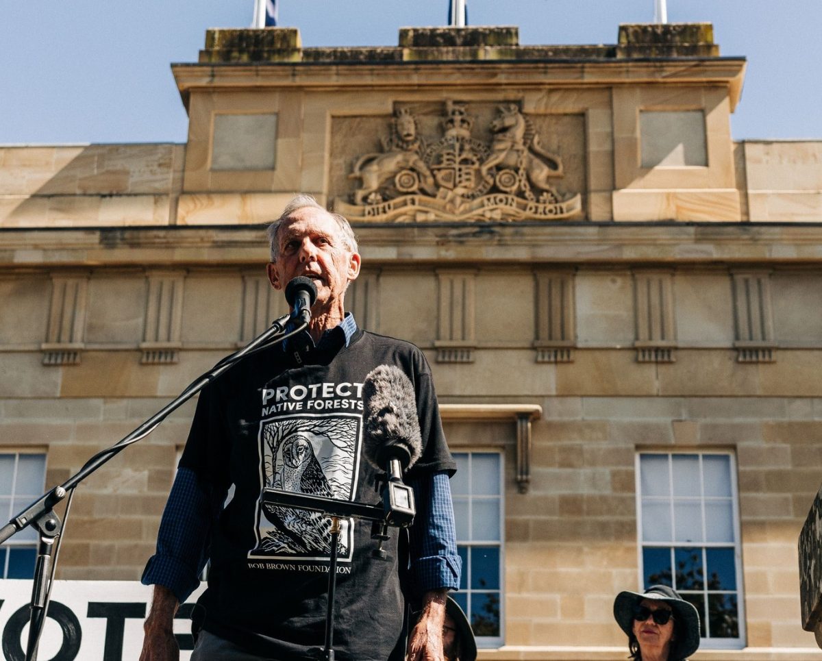 Bob Brown speaking on a platform in front of Tasmanian Parliament House.